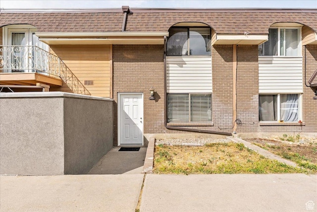 1454 Lancelot Dr, Provo, UT 84601 - entrance to property with brick siding, mansard roof, and roof with shingles