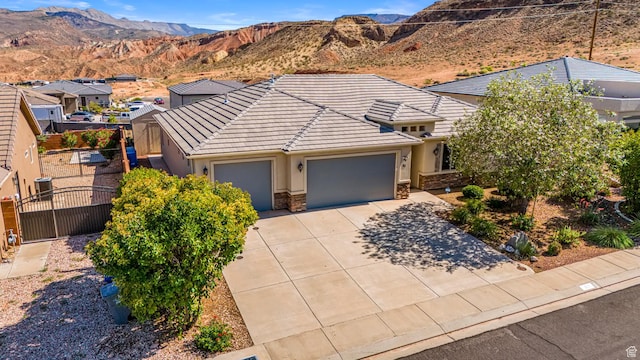 93 E 700 N, La Verkin, UT 84745 - view of front of house with a garage, driveway, a gate, stucco siding, and a tiled roof