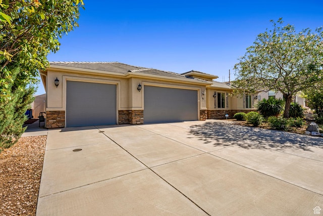 93 E 700 N, La Verkin, UT 84745 - prairie-style house with an attached garage, concrete driveway, stone siding, a tile roof, and stucco siding