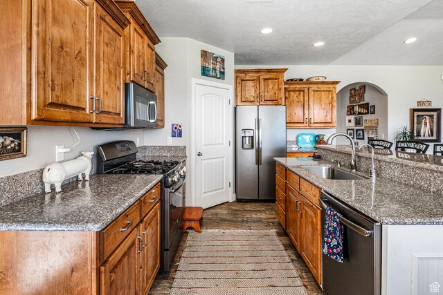 93 E 700 N, La Verkin, UT 84745 - kitchen featuring stainless steel fridge, range with gas stovetop, dishwashing machine, black microwave, and brown cabinets