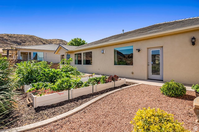 93 E 700 N, La Verkin, UT 84745 - back of property with a garden, stucco siding, and a mountain view