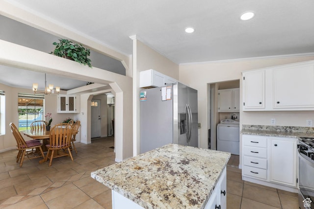 1309 Pine Canyon Rd, Tooele, UT 84074 - kitchen with stainless steel fridge, washer / clothes dryer, white cabinetry, a chandelier, and light stone counters
