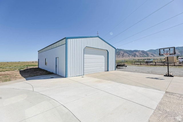 1309 Pine Canyon Rd, Tooele, UT 84074 - detached garage featuring concrete driveway and a mountain view