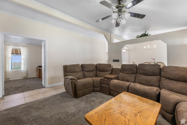 1309 Pine Canyon Rd, Tooele, UT 84074 - living area with light colored carpet, light tile patterned flooring, a ceiling fan, a chandelier, and arched walkways