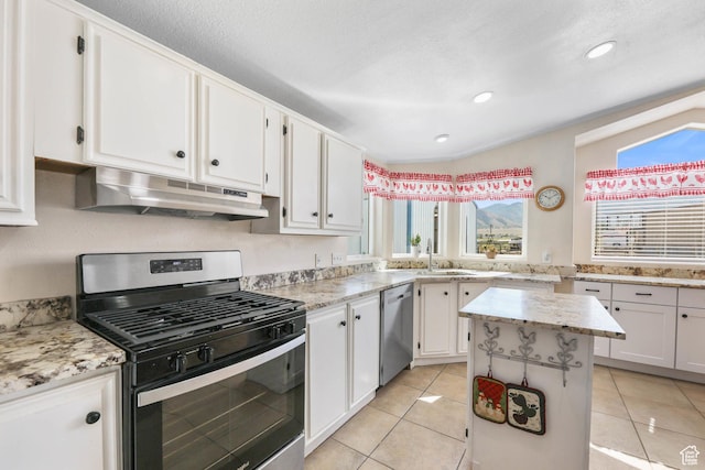 1309 Pine Canyon Rd, Tooele, UT 84074 - kitchen featuring stainless steel appliances, under cabinet range hood, white cabinetry, light tile patterned floors, and recessed lighting