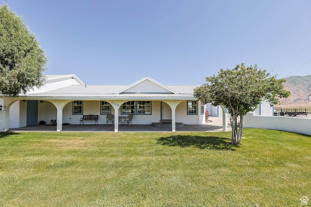 1309 Pine Canyon Rd, Tooele, UT 84074 - rear view of house with a lawn and stucco siding