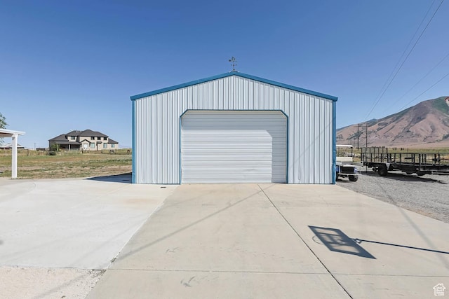 1309 Pine Canyon Rd, Tooele, UT 84074 - detached garage with driveway and a mountain view