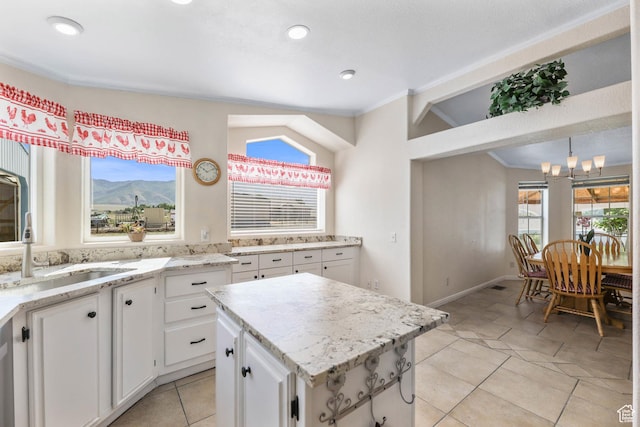 1309 Pine Canyon Rd, Tooele, UT 84074 - kitchen with a chandelier, white cabinetry, a center island, light tile patterned floors, and ornamental molding