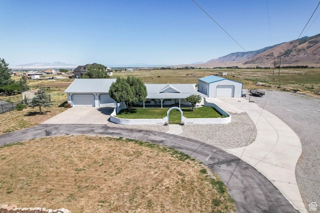 1309 Pine Canyon Rd, Tooele, UT 84074 - ranch-style home with a mountain view, a garage, and a front yard