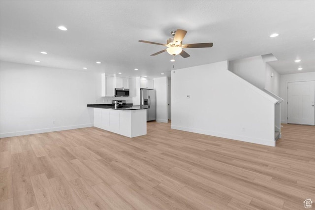 221 W 815 N Unit 21, Nephi, UT 84648 - unfurnished living room with recessed lighting, ceiling fan, stairway, and light wood-style flooring
