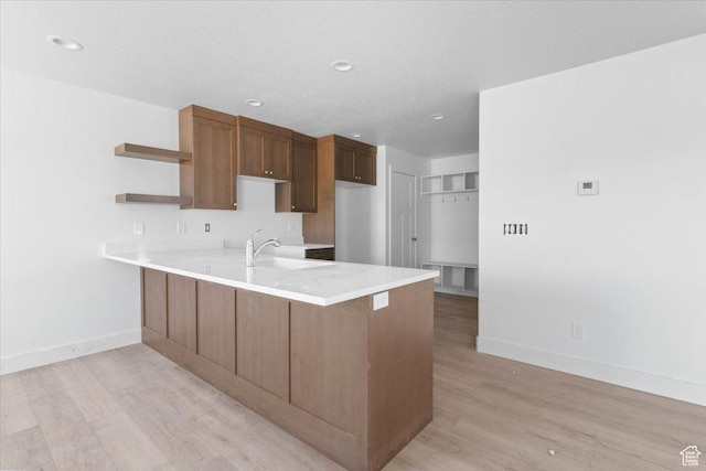 221 W 815 N Unit 21, Nephi, UT 84648 - kitchen with a peninsula, open shelves, light wood finished floors, light countertops, and recessed lighting