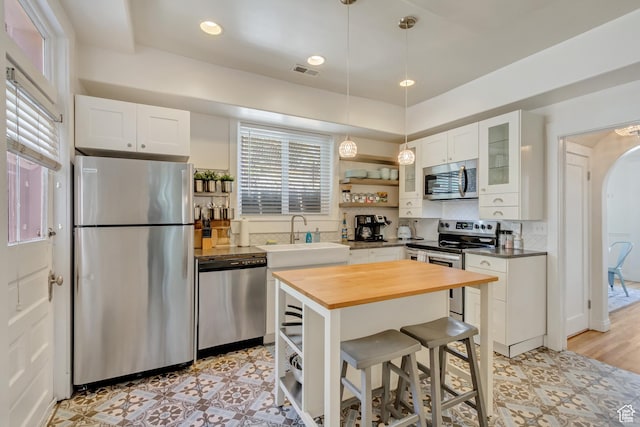 22 W 300 N, Salt Lake City, UT 84103 - kitchen featuring stainless steel appliances, wooden counters, open shelves, white cabinets, and glass insert cabinets