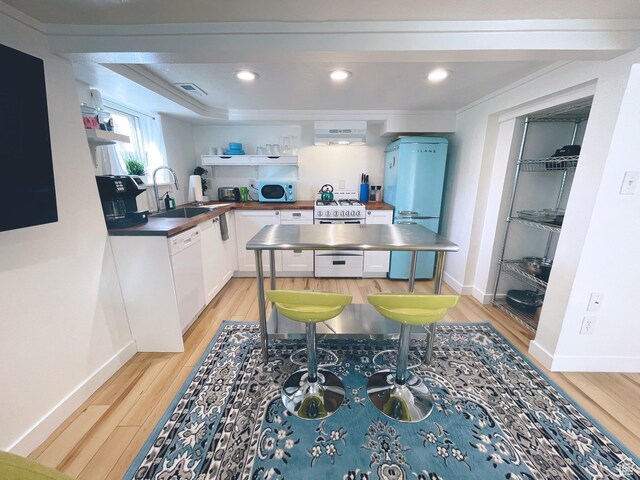 22 W 300 N, Salt Lake City, UT 84103 - kitchen with white appliances, under cabinet range hood, light wood-style flooring, white cabinetry, and open shelves