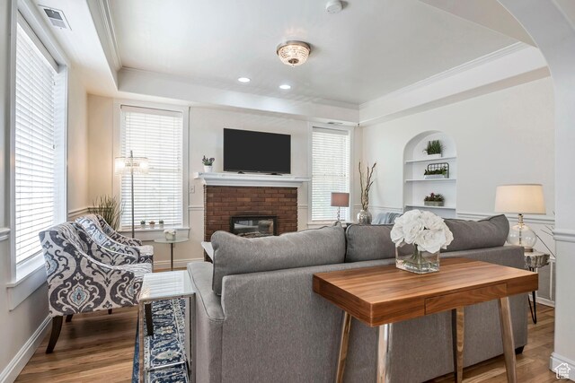 22 W 300 N, Salt Lake City, UT 84103 - living area with a tray ceiling, built in features, arched walkways, a brick fireplace, and crown molding