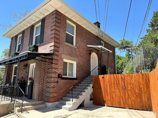 22 W 300 N, Salt Lake City, UT 84103 - view of front of home featuring brick siding and a chimney