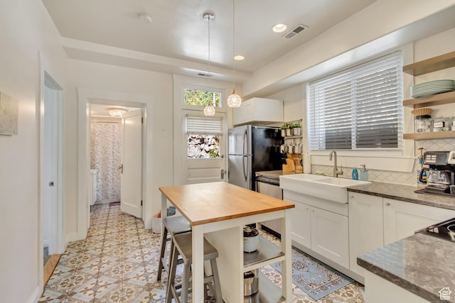 22 W 300 N, Salt Lake City, UT 84103 - kitchen with freestanding refrigerator, open shelves, butcher block counters, white cabinets, and decorative light fixtures