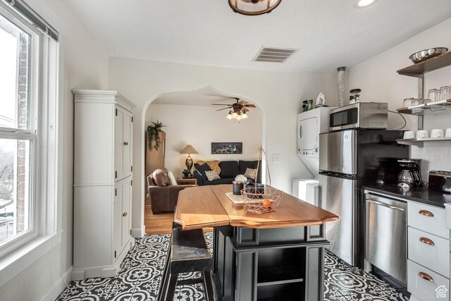 22 W 300 N, Salt Lake City, UT 84103 - kitchen with estacked washer and dryer, open shelves, stainless steel appliances, white cabinets, and recessed lighting
