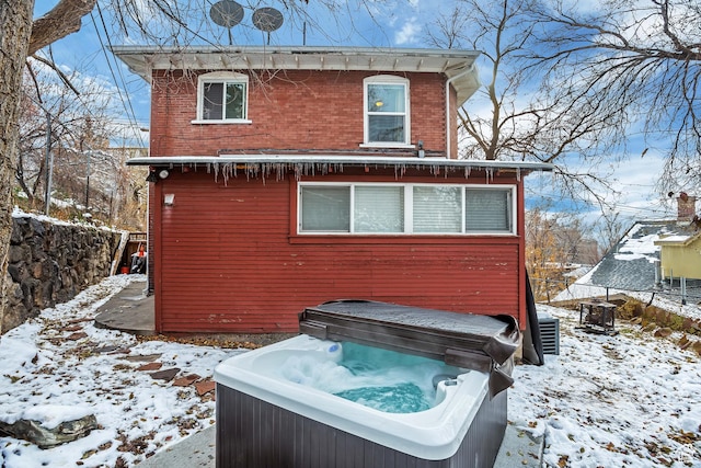 22 W 300 N, Salt Lake City, UT 84103 - snow covered back of property featuring a hot tub and brick siding