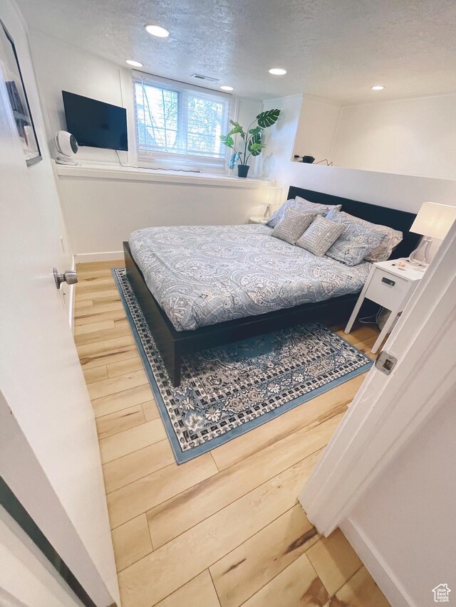 22 W 300 N, Salt Lake City, UT 84103 - bedroom with a textured ceiling, wood finished floors, and recessed lighting