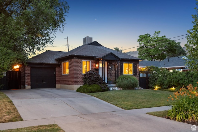 1026 W 800 N, Salt Lake City, UT 84116 - view of front of home with brick siding, a garage, driveway, and a chimney