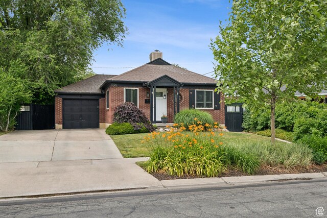 1026 W 800 N, Salt Lake City, UT 84116 - view of front of house with concrete driveway, a garage, brick siding, a shingled roof, and a chimney