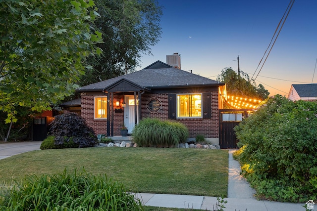 1026 W 800 N, Salt Lake City, UT 84116 - view of front facade with brick siding, a front lawn, a chimney, and a shingled roof
