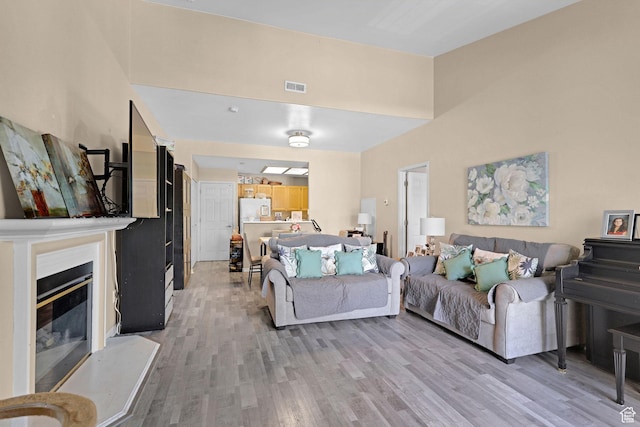 3827 S Big River Way W Unit 3, South Salt Lake, UT 84119 - living area with light wood finished floors and a glass covered fireplace