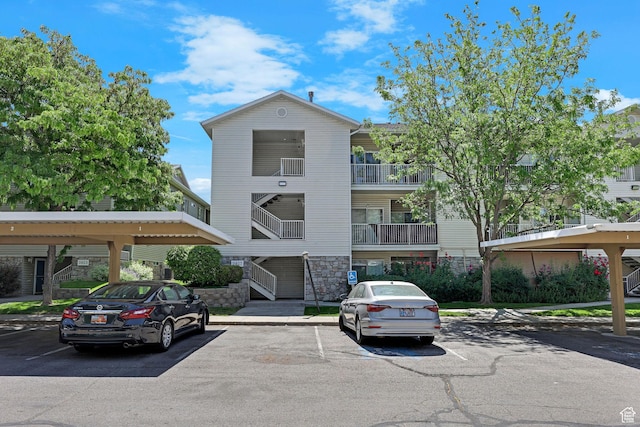3827 S Big River Way W Unit 3, South Salt Lake, UT 84119 - view of building exterior featuring covered and uncovered parking