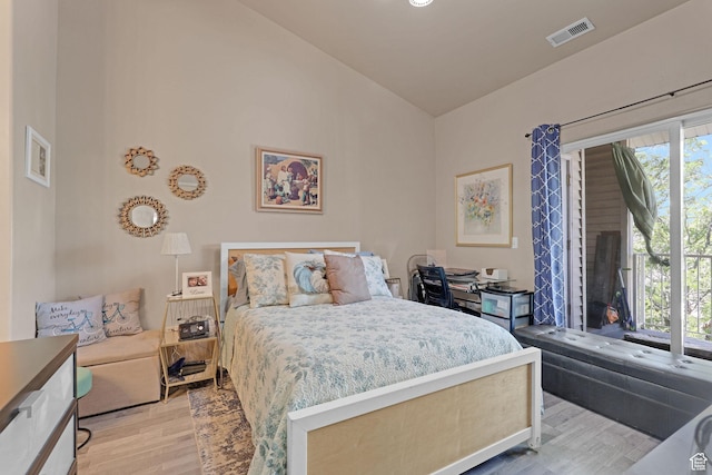 3827 S Big River Way W Unit 3, South Salt Lake, UT 84119 - bedroom with lofted ceiling and light wood-style flooring