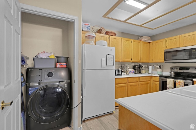 3827 S Big River Way W Unit 3, South Salt Lake, UT 84119 - kitchen featuring stainless steel appliances, washer / dryer, light brown cabinetry, light wood-style flooring, and light countertops