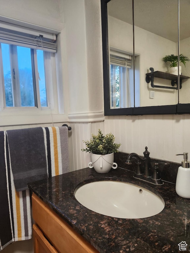 280 E Franklin St S, Ogden, UT 84401 - bathroom featuring vanity, wainscoting, and a decorative wall