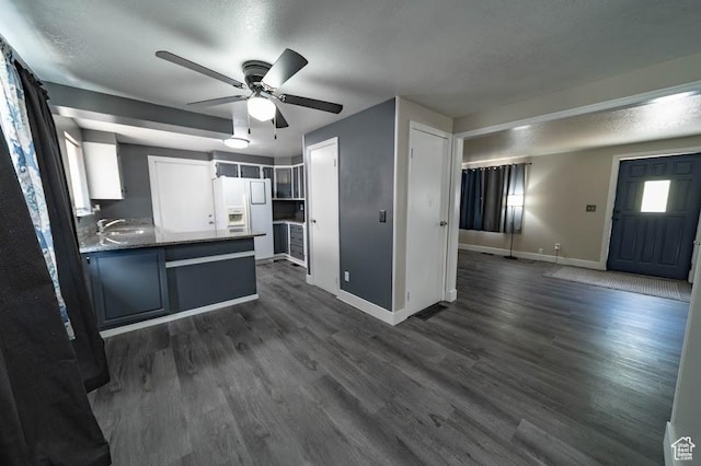 195 N 800 W, Cleveland, UT 84518 - kitchen featuring white fridge with ice dispenser, ceiling fan, a peninsula, dark wood-style flooring, and dark countertops