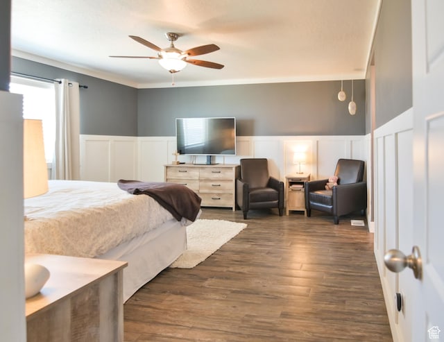 3319 N Falcon Way, Layton, UT 84040 - bedroom with a decorative wall, a wainscoted wall, dark wood-style flooring, crown molding, and a ceiling fan