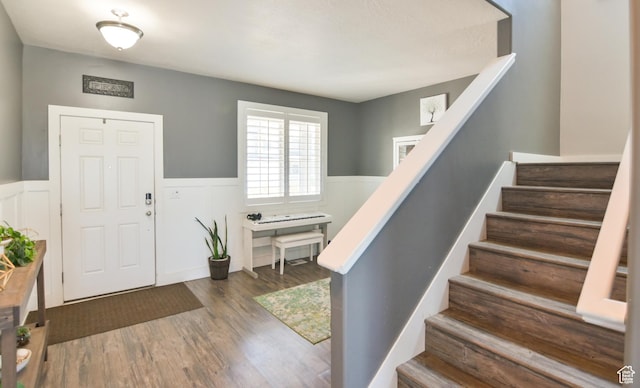 3319 N Falcon Way, Layton, UT 84040 - foyer featuring wainscoting, wood finished floors, stairs, and a decorative wall