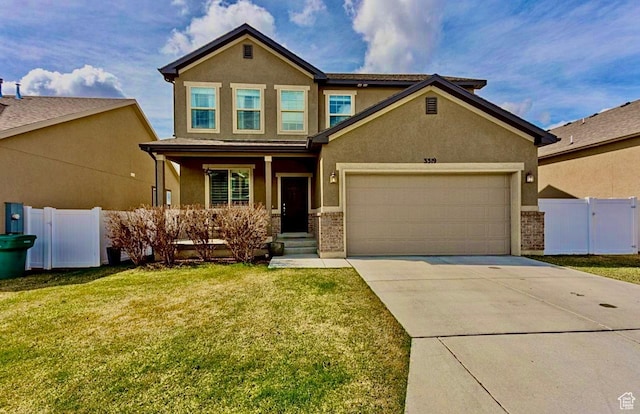 3319 N Falcon Way, Layton, UT 84040 - view of front facade featuring stucco siding, covered porch, a garage, and concrete driveway