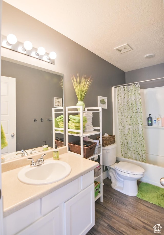 3319 N Falcon Way, Layton, UT 84040 - bathroom featuring vanity, wood finished floors, shower / tub combo, and a textured ceiling