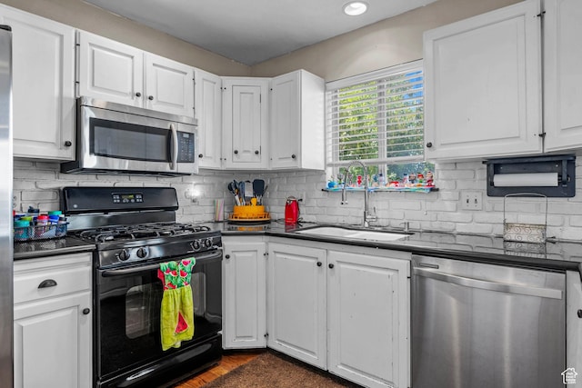 44 S 1000 E, Springville, UT 84663 - kitchen with stainless steel appliances, dark countertops, white cabinetry, and tasteful backsplash