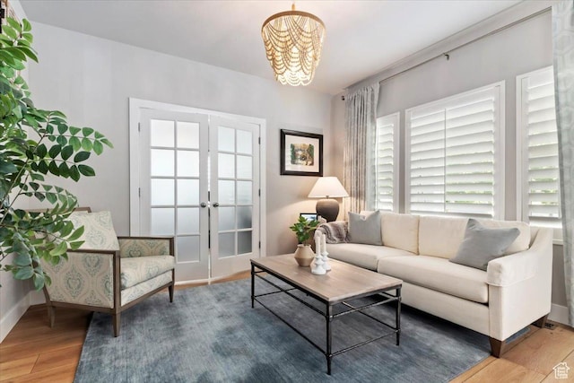 5057 W Bowstring Way S, South Jordan, UT 84009 - living area featuring wood finished floors, a chandelier, french doors, and healthy amount of natural light