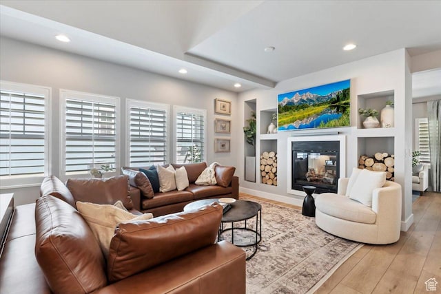 5057 W Bowstring Way S, South Jordan, UT 84009 - living area featuring recessed lighting, a glass covered fireplace, light wood finished floors, and built in shelves