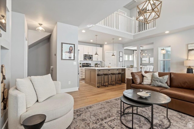 5057 W Bowstring Way S, South Jordan, UT 84009 - living room with a chandelier, light wood-type flooring, recessed lighting, and a high ceiling