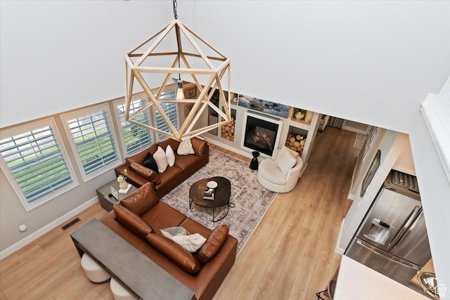 5057 W Bowstring Way S, South Jordan, UT 84009 - living area with wood finished floors and a glass covered fireplace