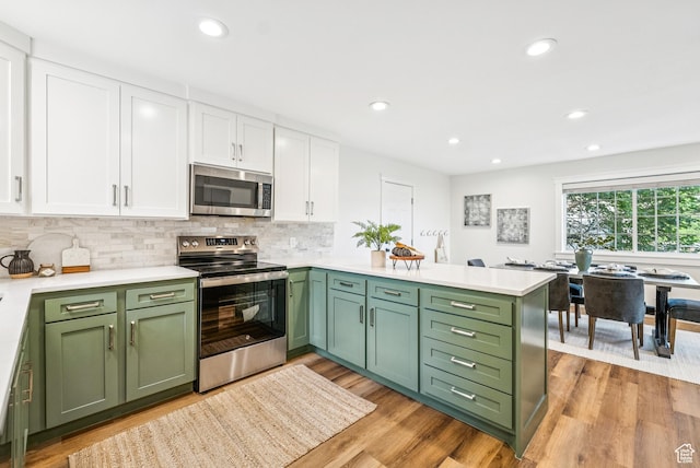 8816 S Alpen Way E, Cottonwood Heights, UT 84121 - kitchen featuring stainless steel appliances, green cabinetry, white cabinetry, a peninsula, and recessed lighting