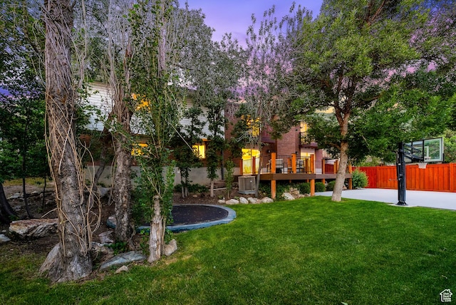 8816 S Alpen Way E, Cottonwood Heights, UT 84121 - yard at dusk with a trampoline and a deck
