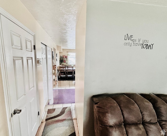 4946 W Pawnee Dr, West Jordan, UT 84081 - hallway with tile patterned flooring and a textured ceiling