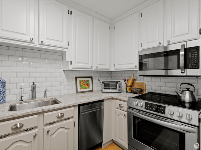 123 E 2nd Ave Unit 502, Salt Lake City, UT 84103 - kitchen with stainless steel appliances, white cabinets, tasteful backsplash, and light stone countertops