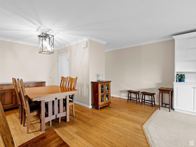 123 E 2nd Ave Unit 502, Salt Lake City, UT 84103 - dining room with light wood-style flooring, a textured ceiling, and crown molding