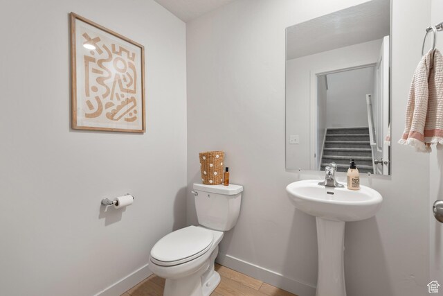 938 W Terracotta Dr, Saratoga Springs, UT 84045 - half bathroom with toilet and wood finished floors