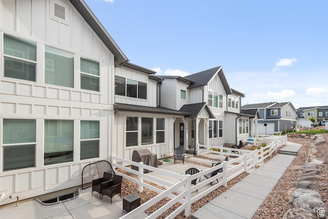 938 W Terracotta Dr, Saratoga Springs, UT 84045 - view of front of house with board and batten siding, a residential view, and a patio area