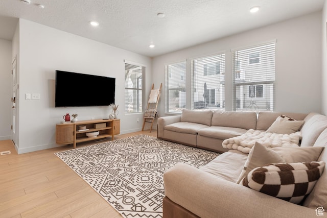 938 W Terracotta Dr, Saratoga Springs, UT 84045 - living room featuring light wood-type flooring, recessed lighting, and a textured ceiling