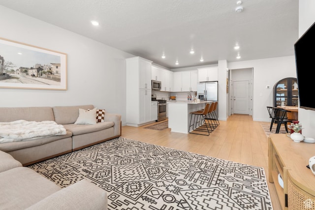 938 W Terracotta Dr, Saratoga Springs, UT 84045 - living room with light wood-type flooring and recessed lighting